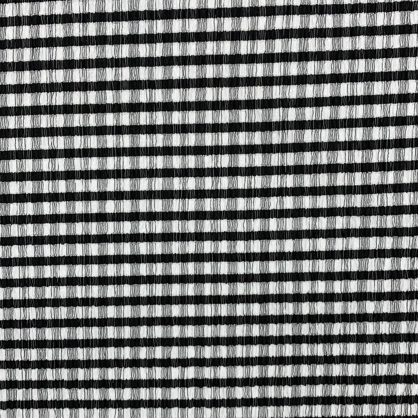 Black and white checkered crepe fabric full view – bold graphic pattern and soft drape
