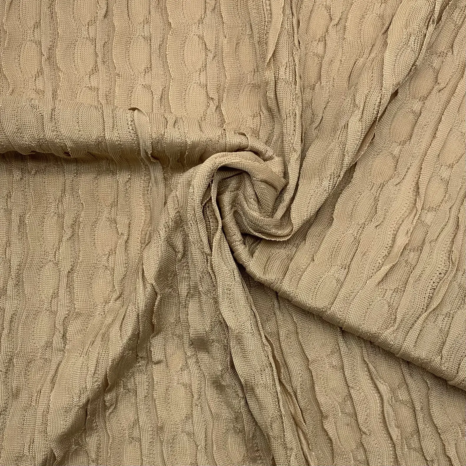 Close up of ruffled lace crepe knit fabric showing textured surface and 4-way stretch