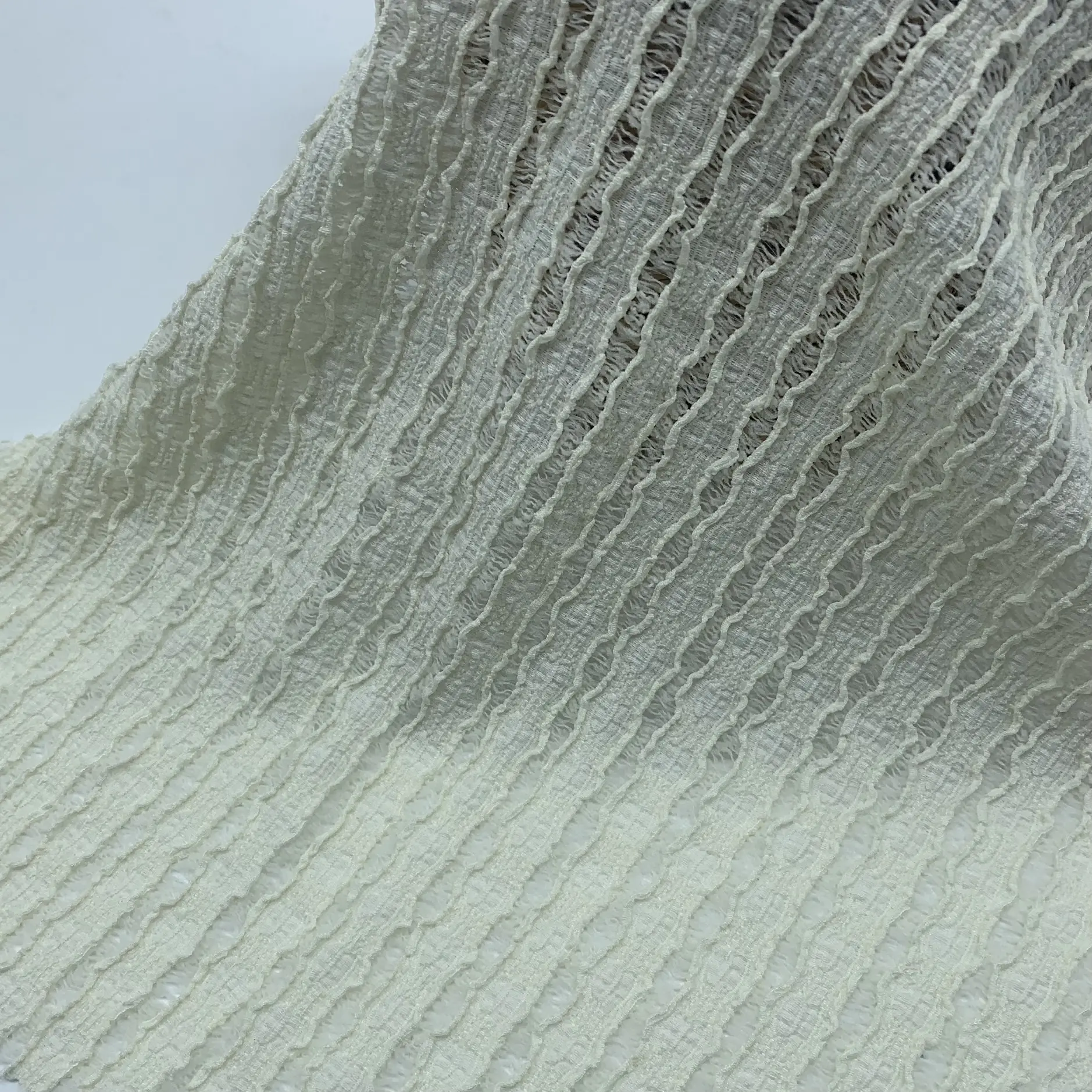 Lace crepe knit fabric full view – textured lace appearance and soft drape