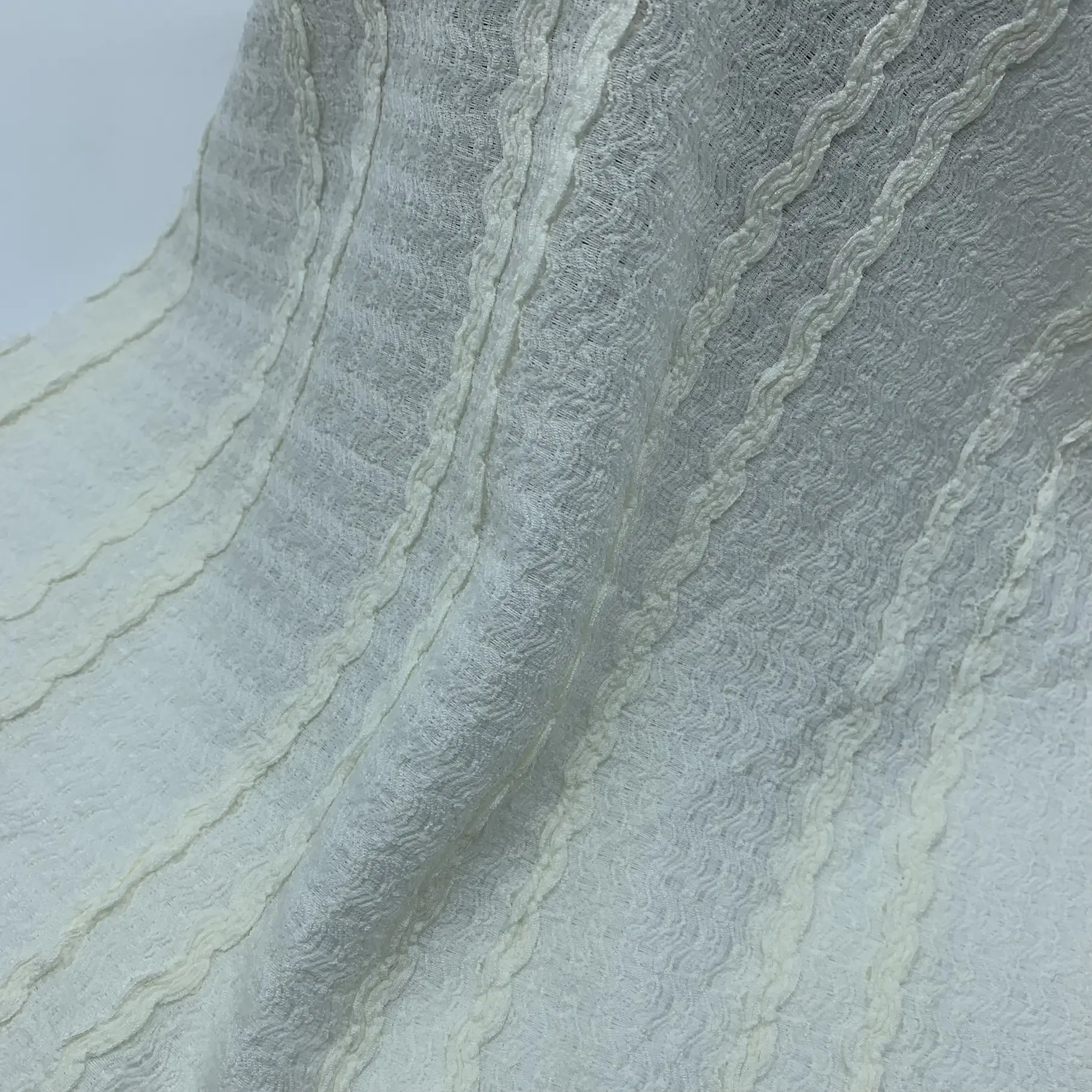 Ruffled crepe lace fabric full view – delicate ruffle texture and soft drape